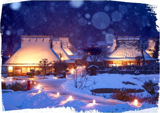 Thatched roof houses decorated with snow