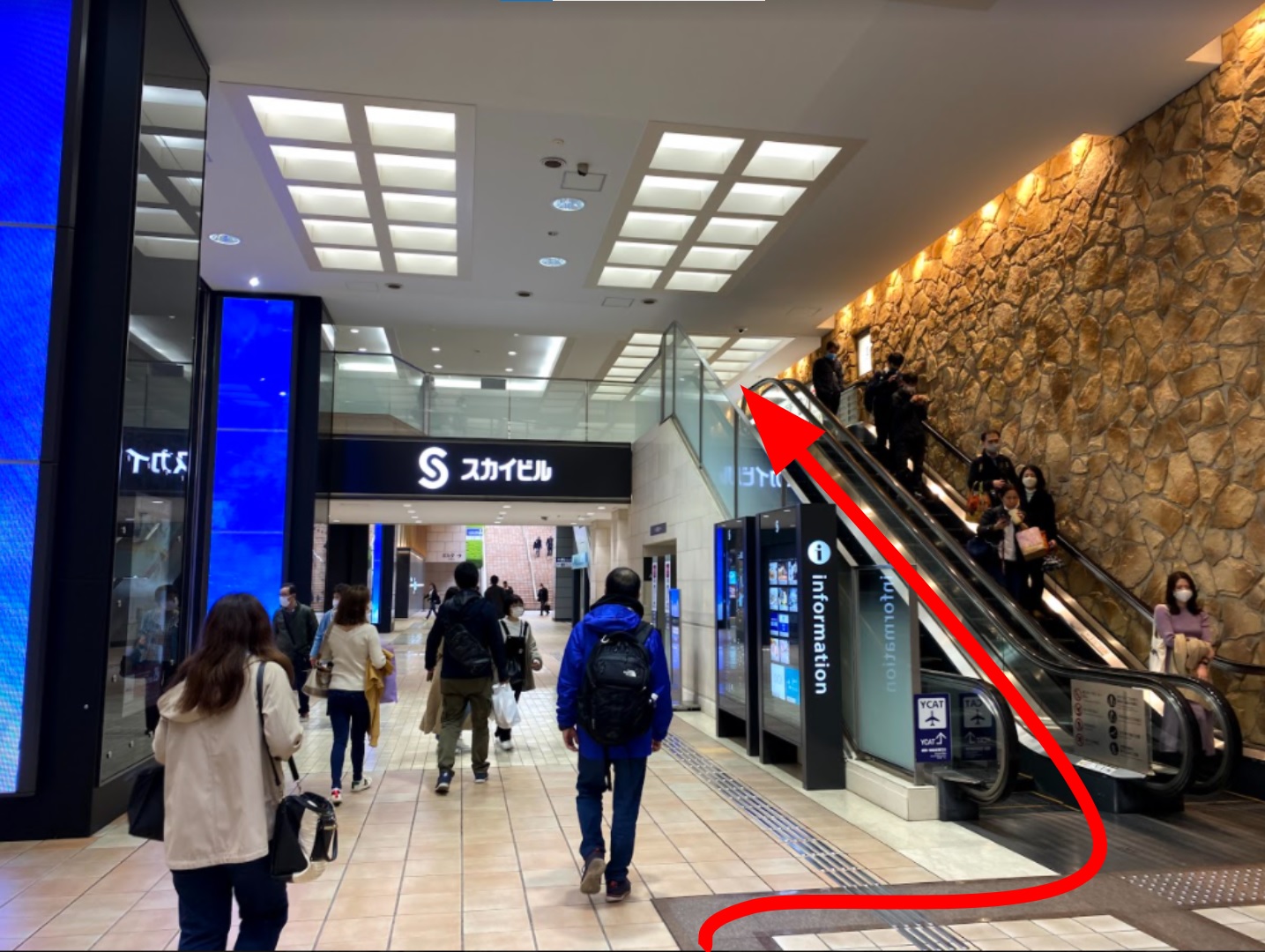  When you see the sign Sky Building, go up the escalator on your right.